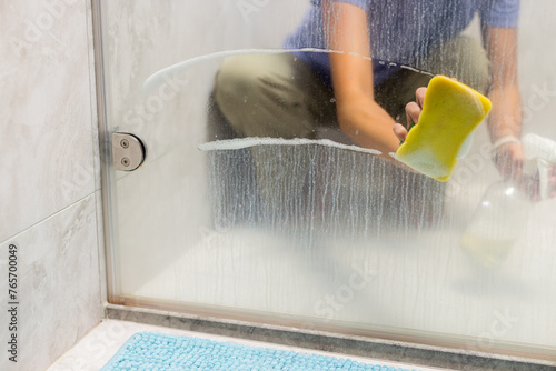 Sponge clean the glass of windows in bathroom