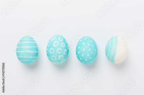 Blue easter eggs on white background, top view