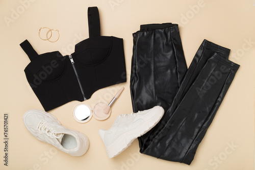 Flat lay with trendy sexy outfit and flowers on color background