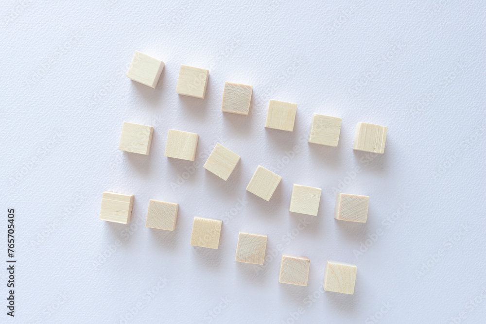 wood cubes arranged in loose rows on paper wood cubes arranged in loose rows on paper