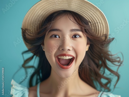 A woman with a big smile on her face and a straw hat on her head