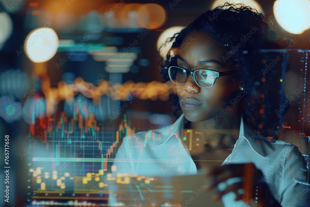 Focused analyst studies complex data charts on screens. Focused analyst studies complex data charts on screens.