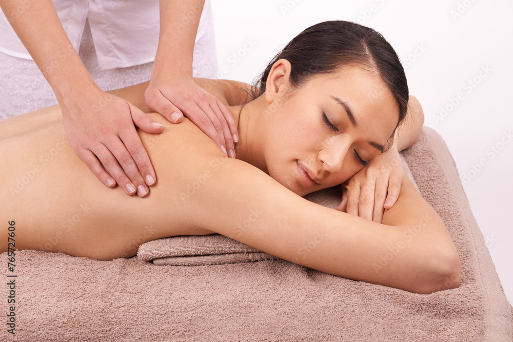 Hands, wellness and woman with back massage at spa for health, self care and grooming treatment in studio. Skin, calm and female person with masseuse for body routine on table by white background. Hands, wellness and woman with back massage at spa for health, self care and grooming treatment in studio. Skin, calm and female person with masseuse for body routine on table by white background.