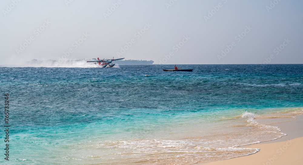 The seaplane takes off on the sea surface and swirls the water.
