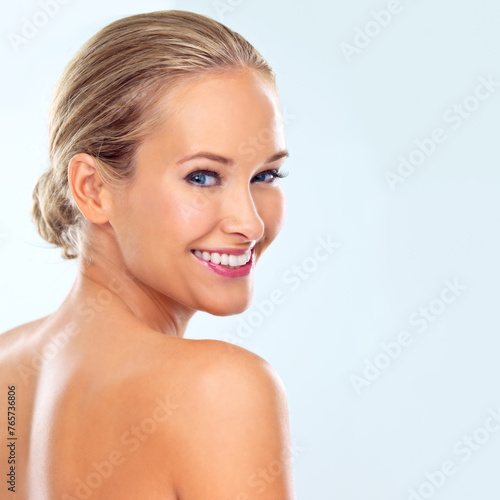 Happy  skincare and portrait of woman in studio for facial treatment  dermatology and cosmetic glow. Female person  smile and confidence with healthy skin  self care and wellness on blue background