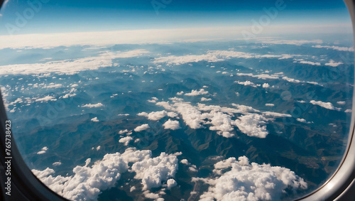 Aerial view captured from an airplane window, showcasing the vast expanse of the sky and earth below.