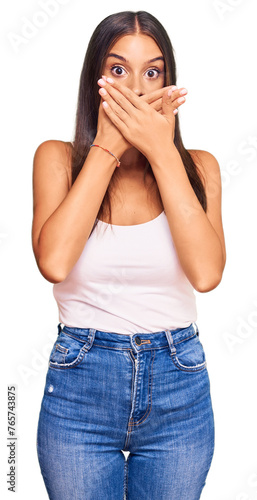 Young hispanic woman wearing casual clothes shocked covering mouth with hands for mistake. secret concept.