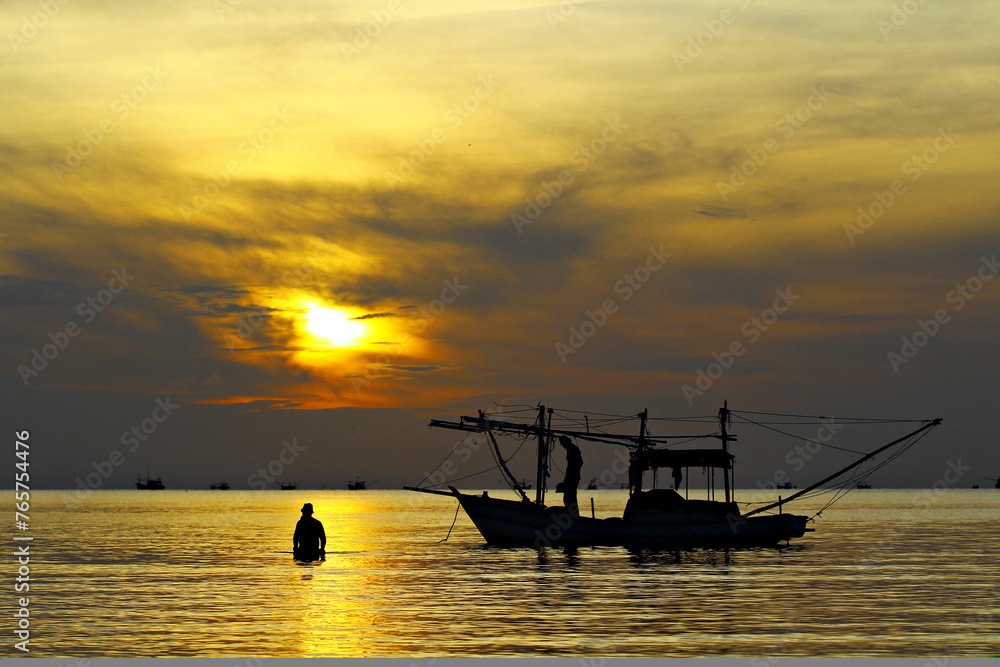 Silhouette fisherman's life at Ao Prachuap Khiri Khan Beach, Prachuap Khiri Khan Province, Thailand Silhouette fisherman's life at Ao Prachuap Khiri Khan Beach, Prachuap Khiri Khan Province, Thailand