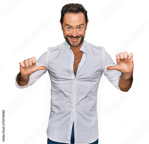 Middle age man wearing casual clothes looking confident with smile on face, pointing oneself with fingers proud and happy.