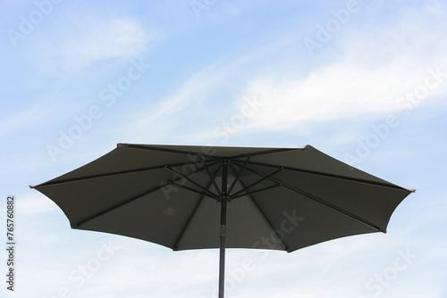 Beautiful beach umbrella, with blue sky behind it, close-up