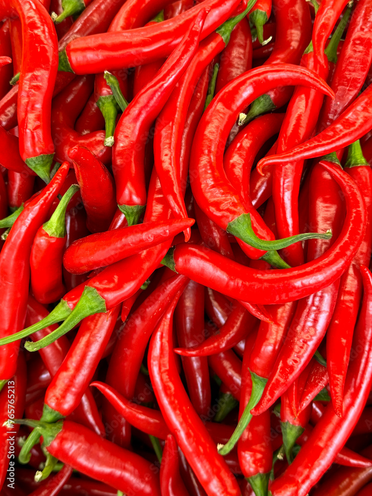 Close-up of bright red chili peppers at a local outdoor market