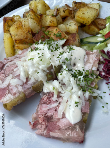 Homemade brawn with remoulade sauce and fried potatoes photo