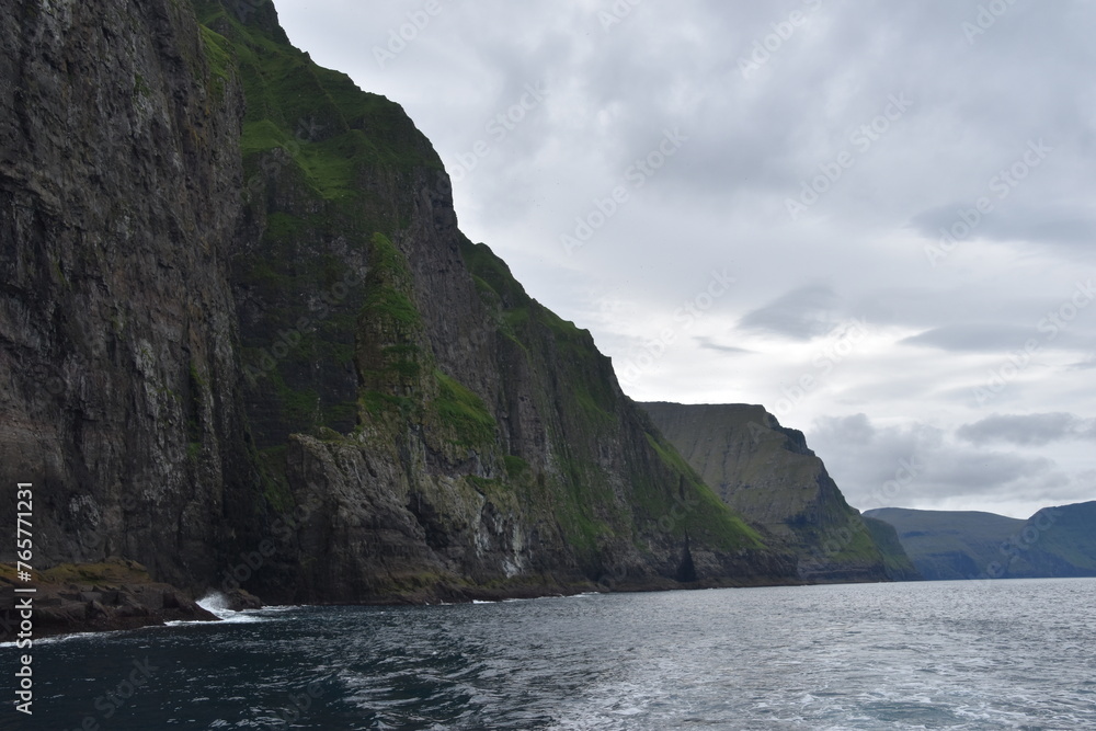The dramatic coastline and green mountains of the Faroe Islands The dramatic coastline and green mountains of the Faroe Islands