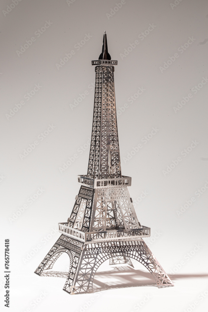 Delicate metal Eiffel Tower model on white background