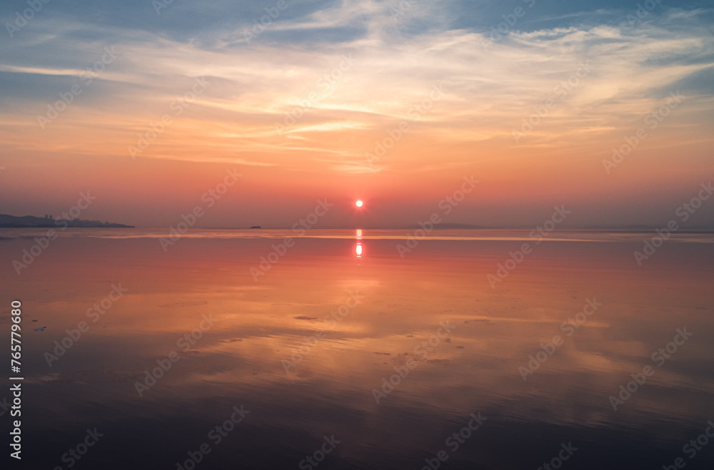 Beautiful sunset over the sea. The sun is reflected in the water.