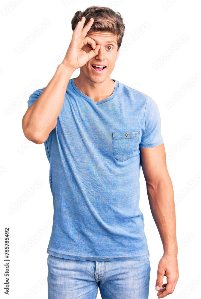 Fototapeta premium Young handsome man wearing casual clothes doing ok gesture with hand smiling, eye looking through fingers with happy face.