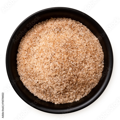 Cinnamon sugar in a black ceramic bowl isolated on white from above. © Moving Moment