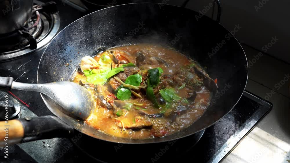 Cooking Home cook style Thai food menu. Catfish curry in a pan on gas stove in the kitchen. Cooking Home cook style Thai food menu. Catfish curry in a pan on gas stove in the kitchen.