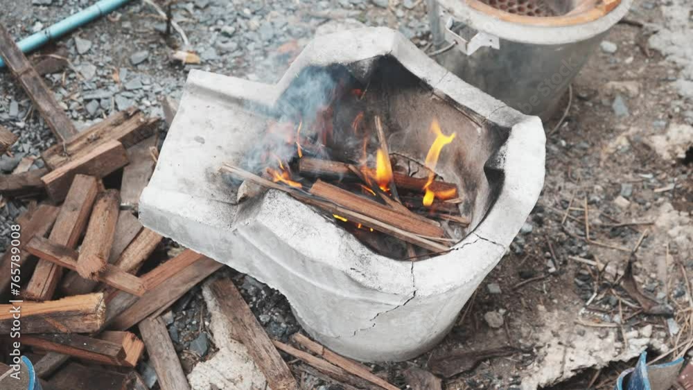Making a fire with firewood from wood chips in charcoal stove mortar. Making a fire with firewood from wood chips in charcoal stove mortar.