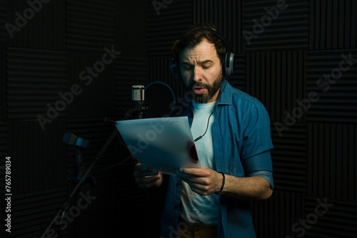Caucasian voice actor recording in soundproof studio