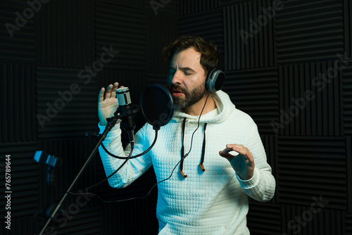 Male vocal artist recording in sound booth