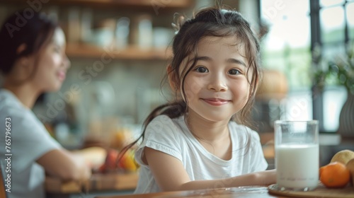 The children are joyfully drinking milk with their parents, enjoying quality time together.