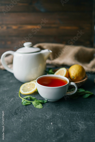 Glass cup with hot tea and lemon on table