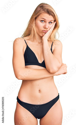 Young beautiful blonde woman wearing bikini thinking looking tired and bored with depression problems with crossed arms. © Krakenimages.com