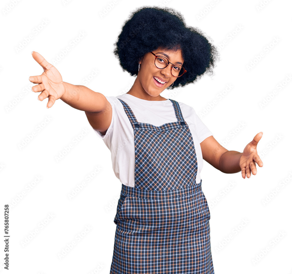 Young african american girl wearing casual clothes looking at the camera smiling with open arms for hug. cheerful expression embracing happiness. Young african american girl wearing casual clothes looking at the camera smiling with open arms for hug. cheerful expression embracing happiness.