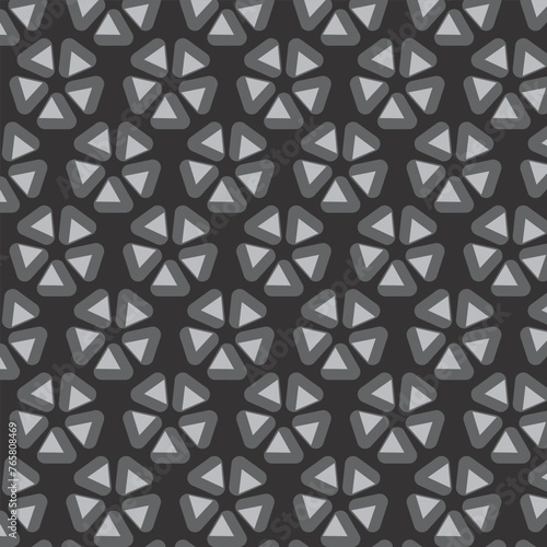 Abstract geometric flower shape. Flower composed of triangles. Gray pattern on a dark background. Abstract repeating pattern.