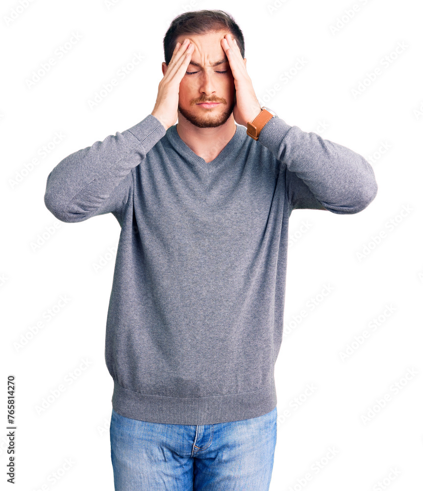 Young handsome caucasian man wearing casual winter sweater suffering from headache desperate and stressed because pain and migraine. hands on head. Young handsome caucasian man wearing casual winter sweater suffering from headache desperate and stressed because pain and migraine. hands on head.