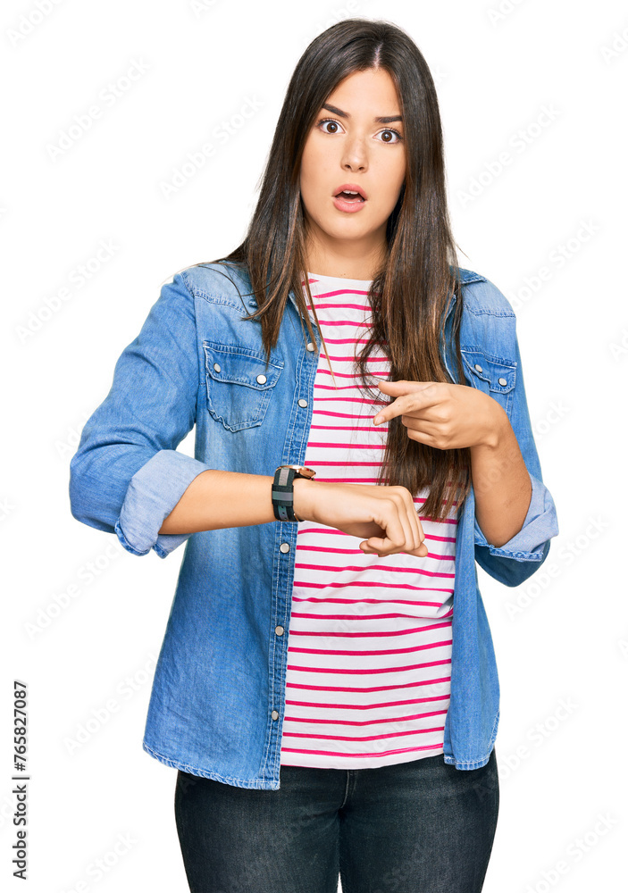 Young brunette woman wearing casual clothes in hurry pointing to watch time, impatience, upset and angry for deadline delay Young brunette woman wearing casual clothes in hurry pointing to watch time, impatience, upset and angry for deadline delay