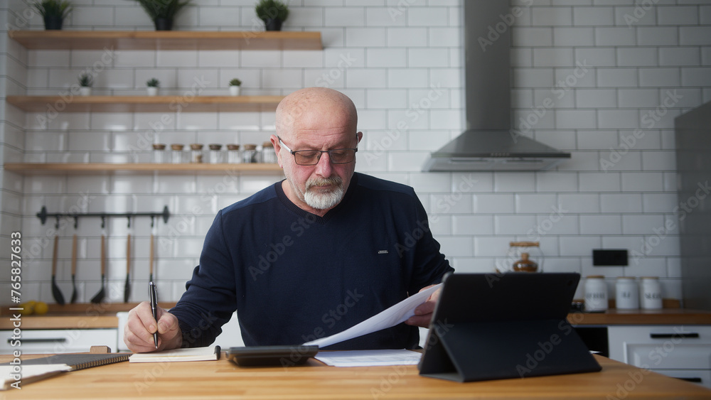 Elderly man sit in the kitchen using tablet device, study financial papers using calculator count expenses, make budget control, manage finances, banking work review mortgage loan insurance payments
Elderly man sit in the kitchen using tablet device, study financial papers using calculator count expenses, make budget control, manage finances, banking work review mortgage loan insurance payments