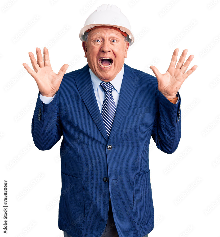 Senior handsome grey-haired man wearing suit and architect hardhat celebrating crazy and amazed for success with arms raised and open eyes screaming excited. winner concept Senior handsome grey-haired man wearing suit and architect hardhat celebrating crazy and amazed for success with arms raised and open eyes screaming excited. winner concept