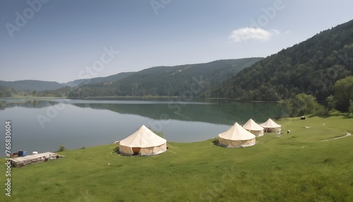 Glamping, few tents, lake on the foreground