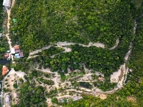 Aerial drone view small Koh Ma island  Ko Phangan Thailand. Exotic coast panoramic landscape  Mae Haad beach  summer day. Sandy path between corals. Vivid seascape  mountain coconut palms from above.