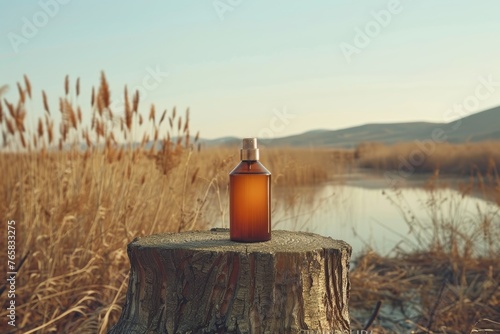 Amber Cosmetic Bottle on Tree Stump in Autumn Reed Landscape