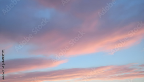 Background of blue sky with pale pink clouds in sunset © Antonina