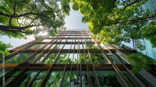 A modern office building embraced by the trees, energy conservation and sustainability concept.