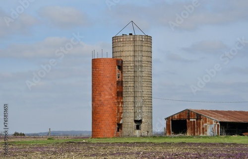 Grain Silos by a Barn