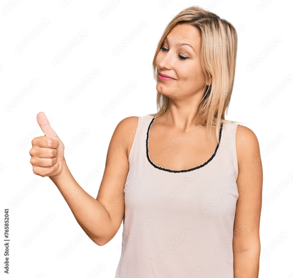 Middle age caucasian woman wearing casual clothes looking proud, smiling doing thumbs up gesture to the side Middle age caucasian woman wearing casual clothes looking proud, smiling doing thumbs up gesture to the side