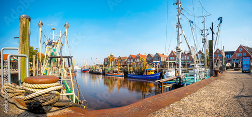 Traditional harbor scene with fishing boats in Neuharlingersiel , Nordsee, Germany photo