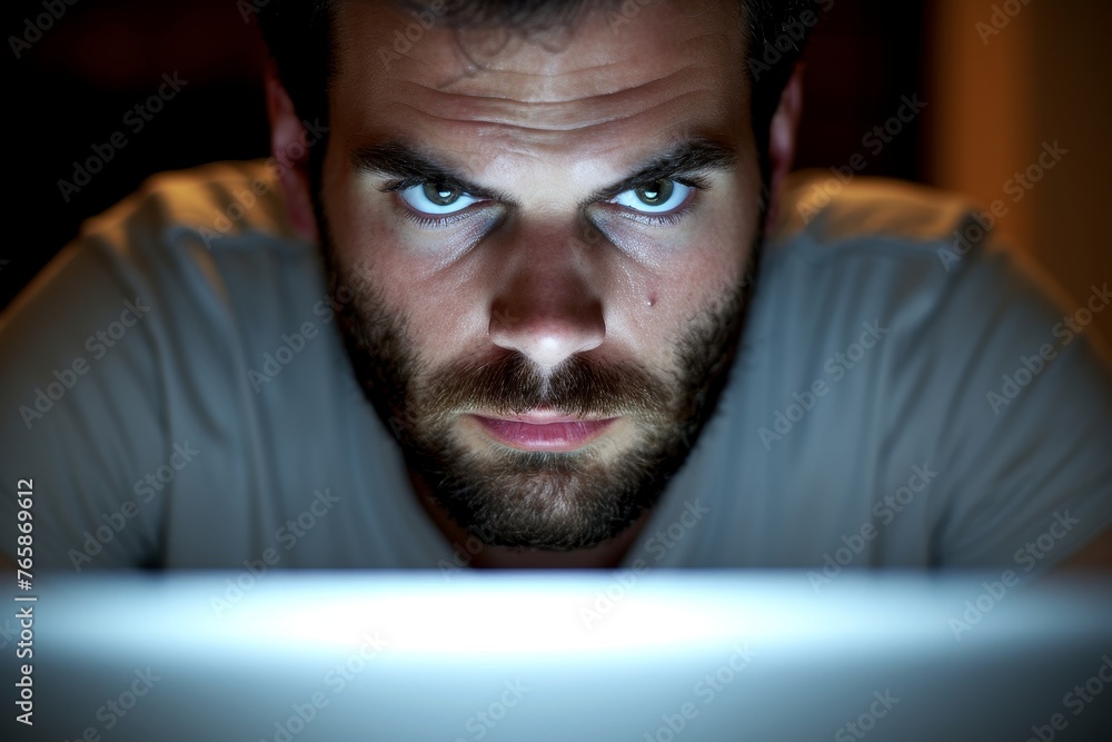 Solitary Figure Working Late at Night, With Computer Screen's Glow Highlighting Exhaustion Under Chaotic Atmosphere.