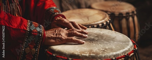 Close up of Red Indian ceremonial drums hands in motion connecting past with present photo