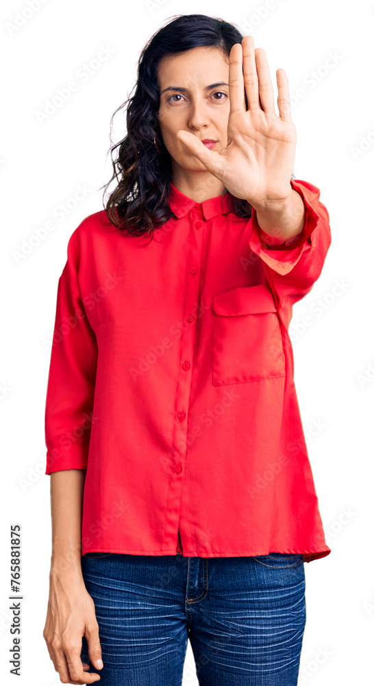 Young beautiful hispanic woman wearing casual clothes doing stop sing with palm of the hand. warning expression with negative and serious gesture on the face. Young beautiful hispanic woman wearing casual clothes doing stop sing with palm of the hand. warning expression with negative and serious gesture on the face.