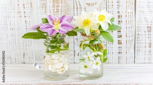  a couple of vases filled with flowers sitting on top of a white wooden table in front of a wooden wall.