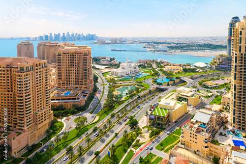 View of the modern Doha skyline with the Doha Pearl island and Sheikh Hamad bin Jassim Mosque in view along the Persian Gulf.  photo