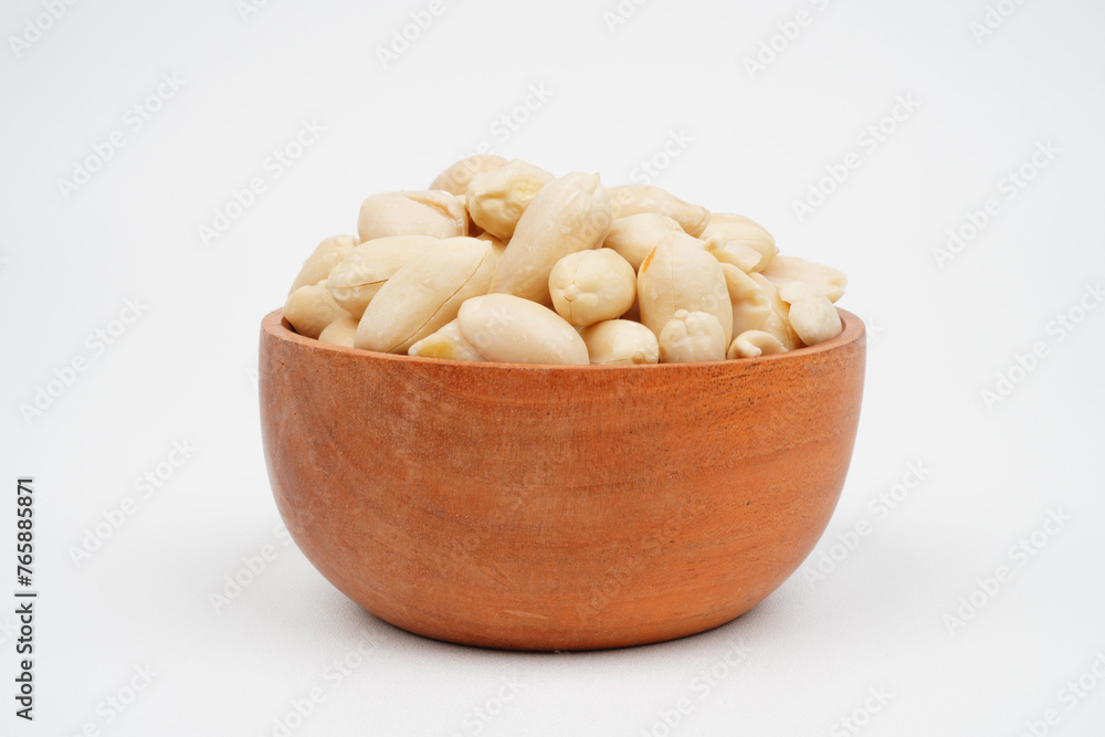 Cooked peanuts in a wooden bowl.Isolated Background Cooked peanuts in a wooden bowl.Isolated Background