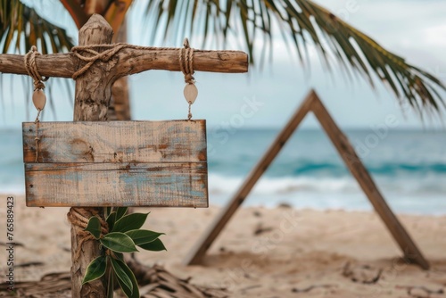 Wooden signboard on a wooden peg on the beach in hawaii in the boho style for a boho wedding  and in the background a slightly blurred triangular wedding gate on the beach  look  generated with AI