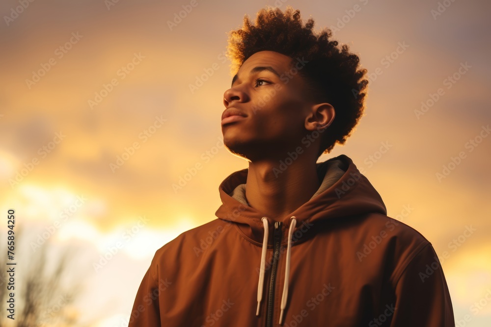 
A portrait in the golden hour, featuring a rucker looking off into the distance, reflective and motivated - obrazy, fototapety, plakaty 